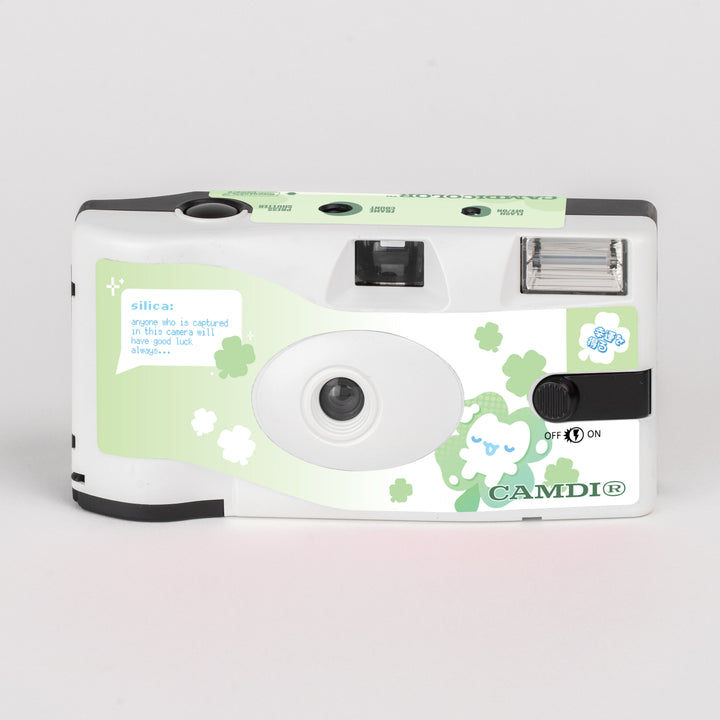 CAMDi NOTFOREATING disposable film camera, white front with green clover artwork.