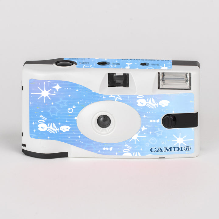CAMDi The Blue Cafe disposable film camera, white front with blue stars and fish artwork.