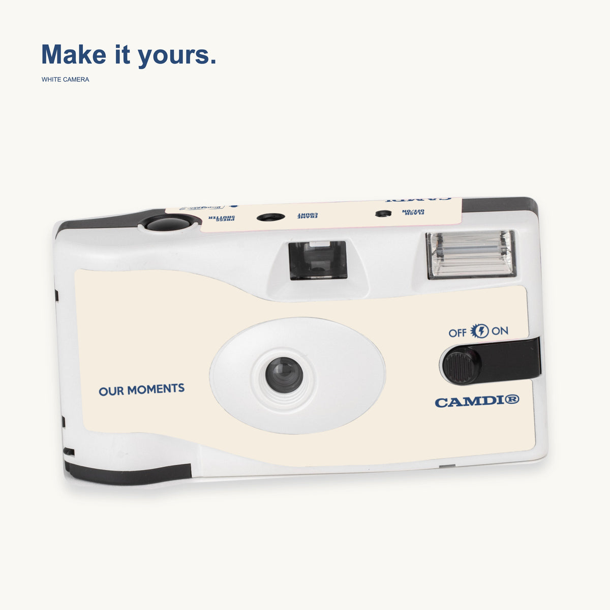 White CAMDi custom disposable camera with a cream OUR MOMENTS design and blue CAMDi lettering.